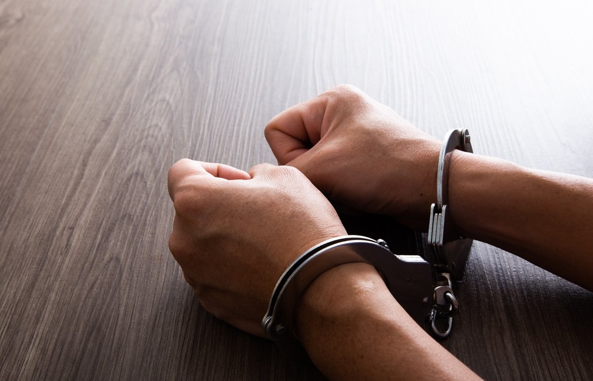 A pair of hands in handcuffs