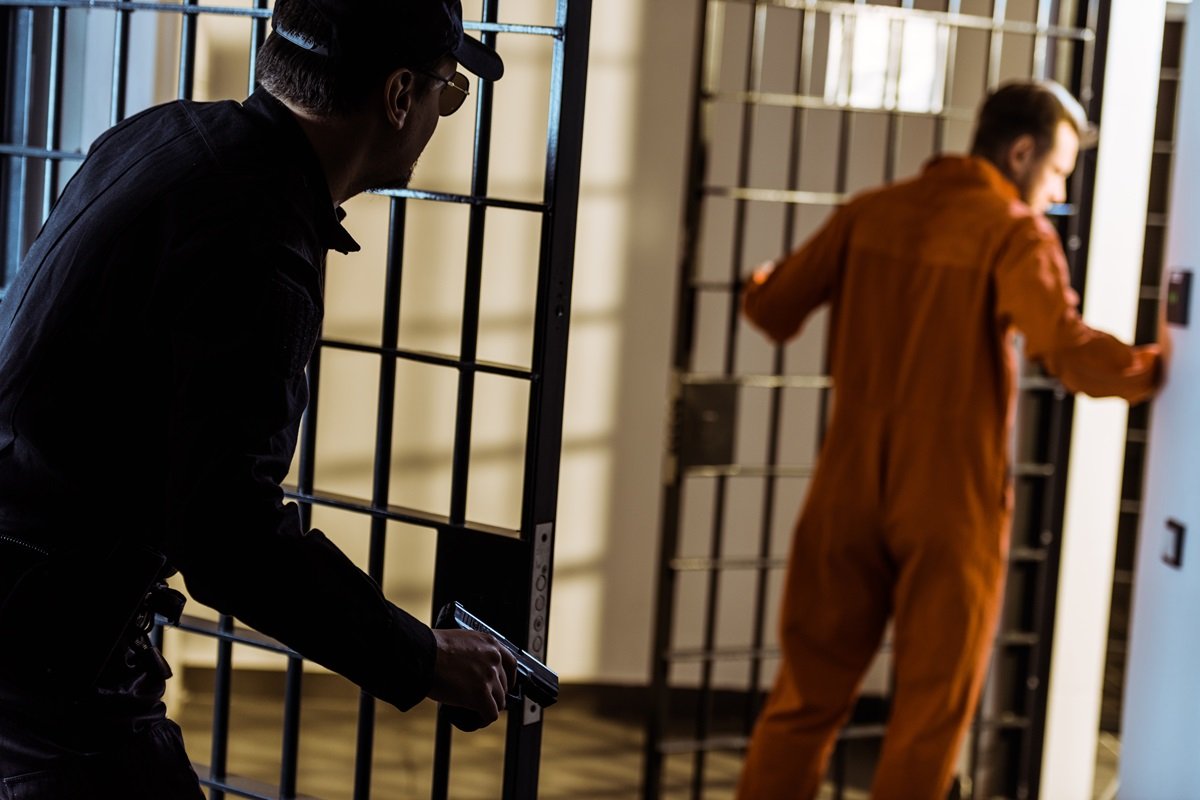 A guard closing the door on a prisoner