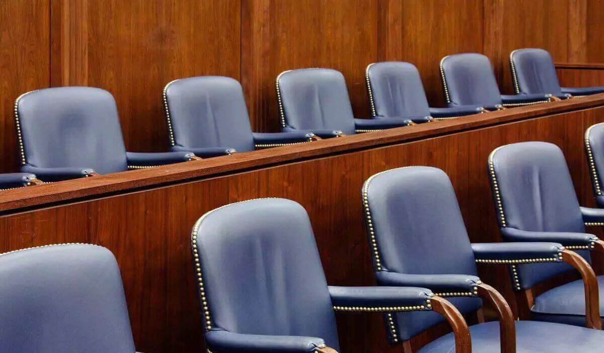 An empty jury section in a courtroom.
