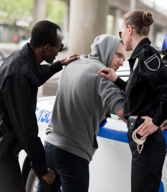 A man being arrested by two police officers