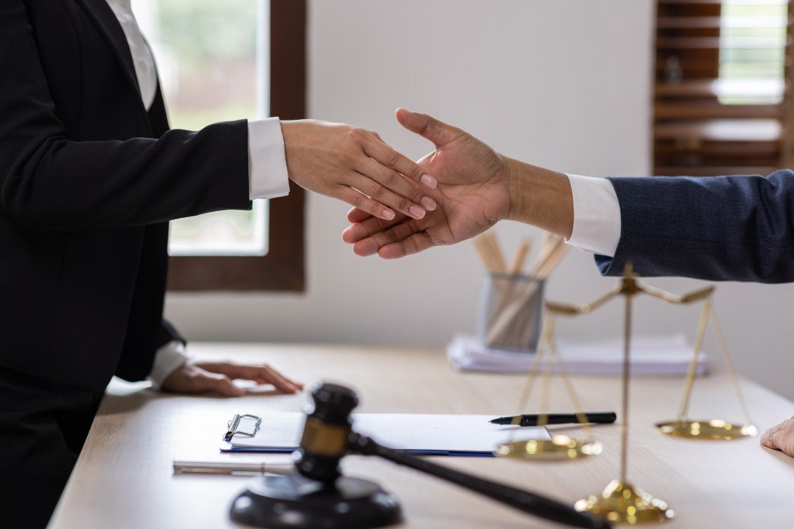 A lawyer shaking hands with a female client