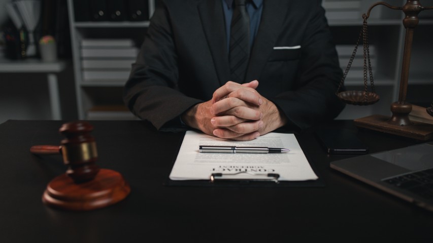 A lawyer sitting on their desk