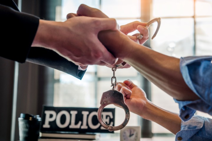 Police putting handcuffs on someone's wrist