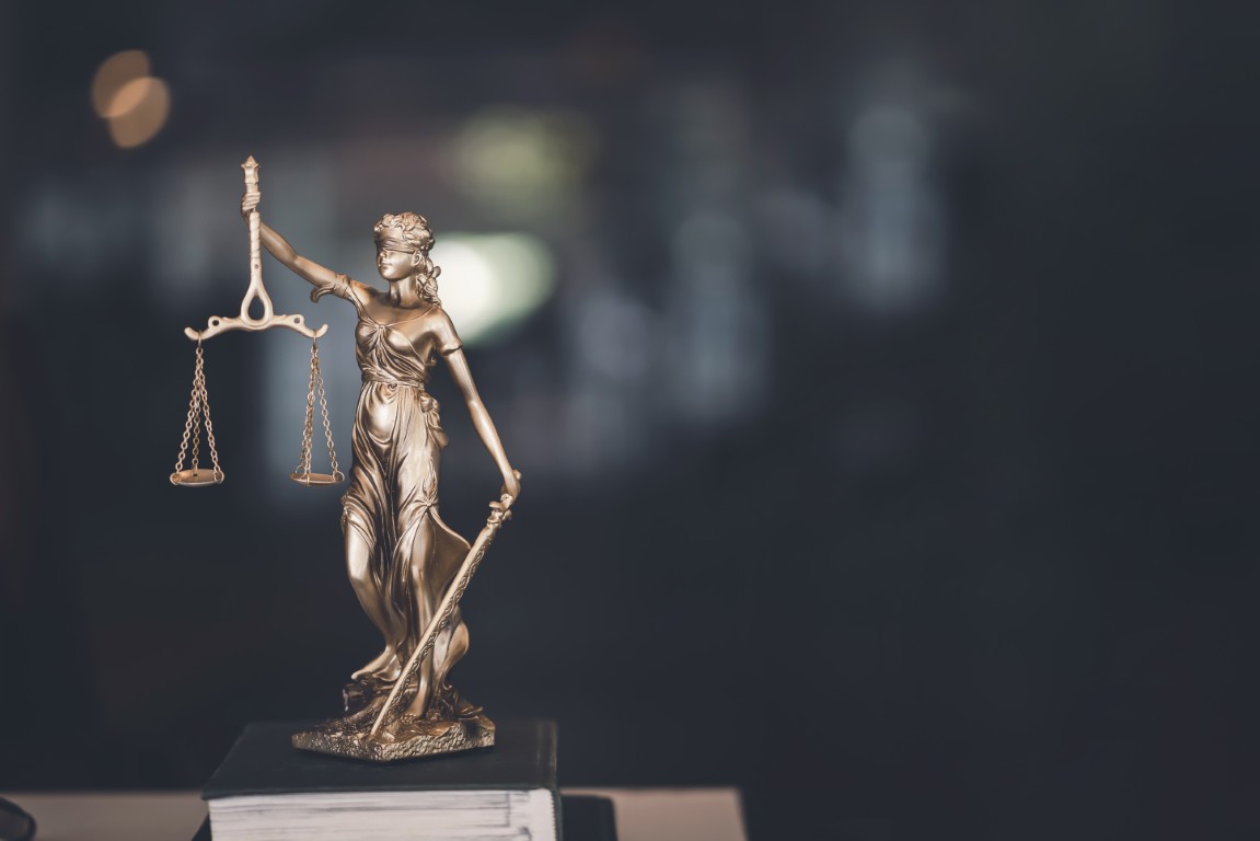 A statue of lady justice on a book