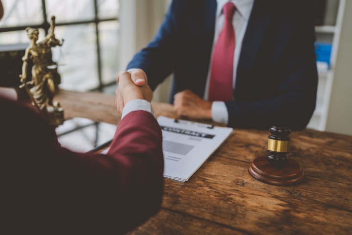 A lawyer and client shaking hands.