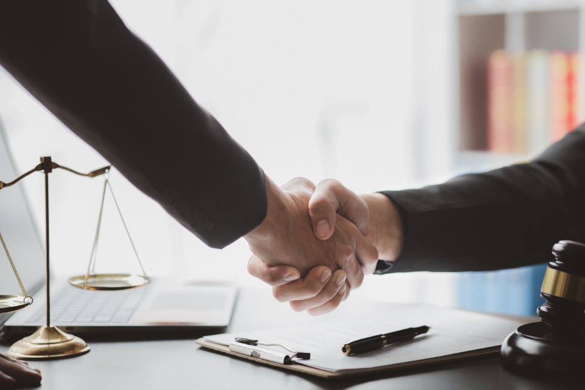 A lawyer shaking hands with a client