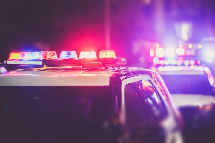 Two police cars parked with the sirens on