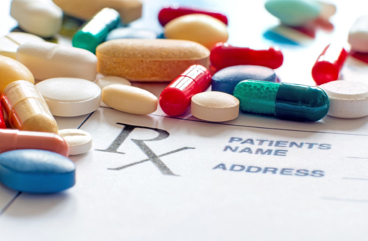 Assorted pills on a prescription pad