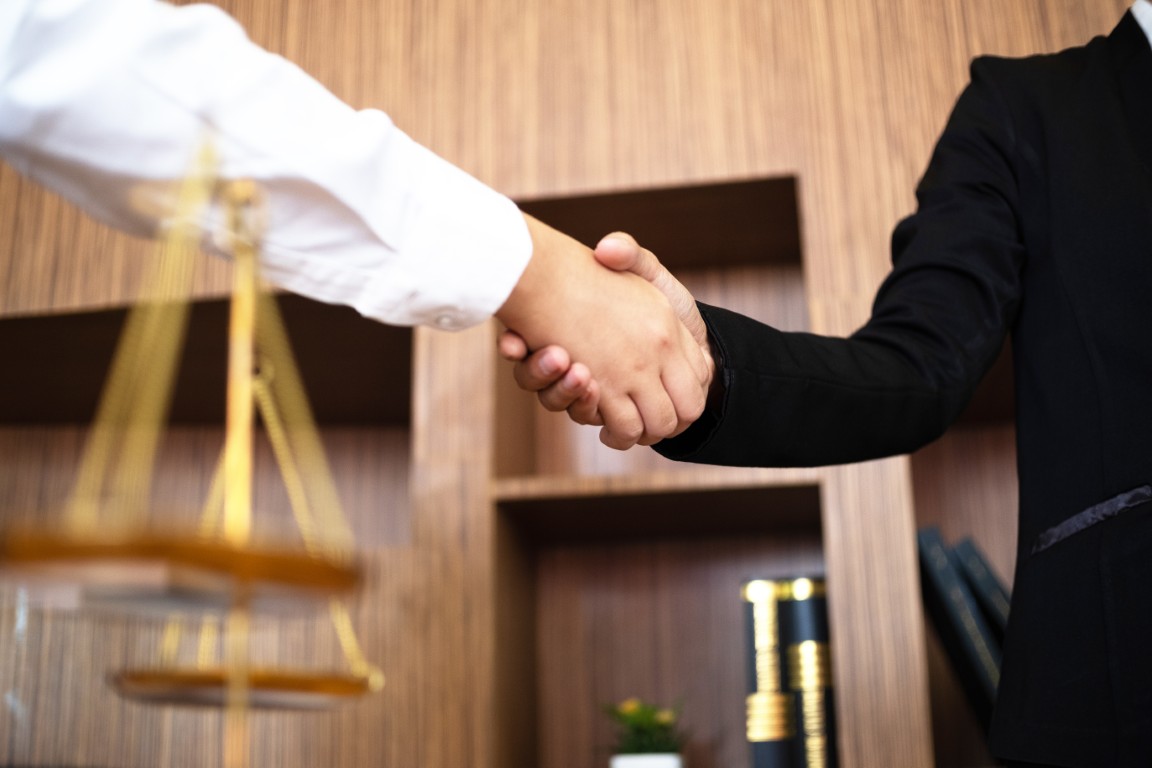 A lawyer shaking hands with a client