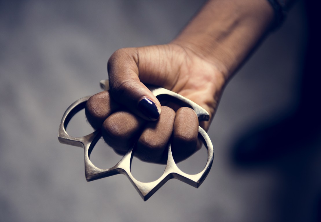 A person with a set of brass knuckles