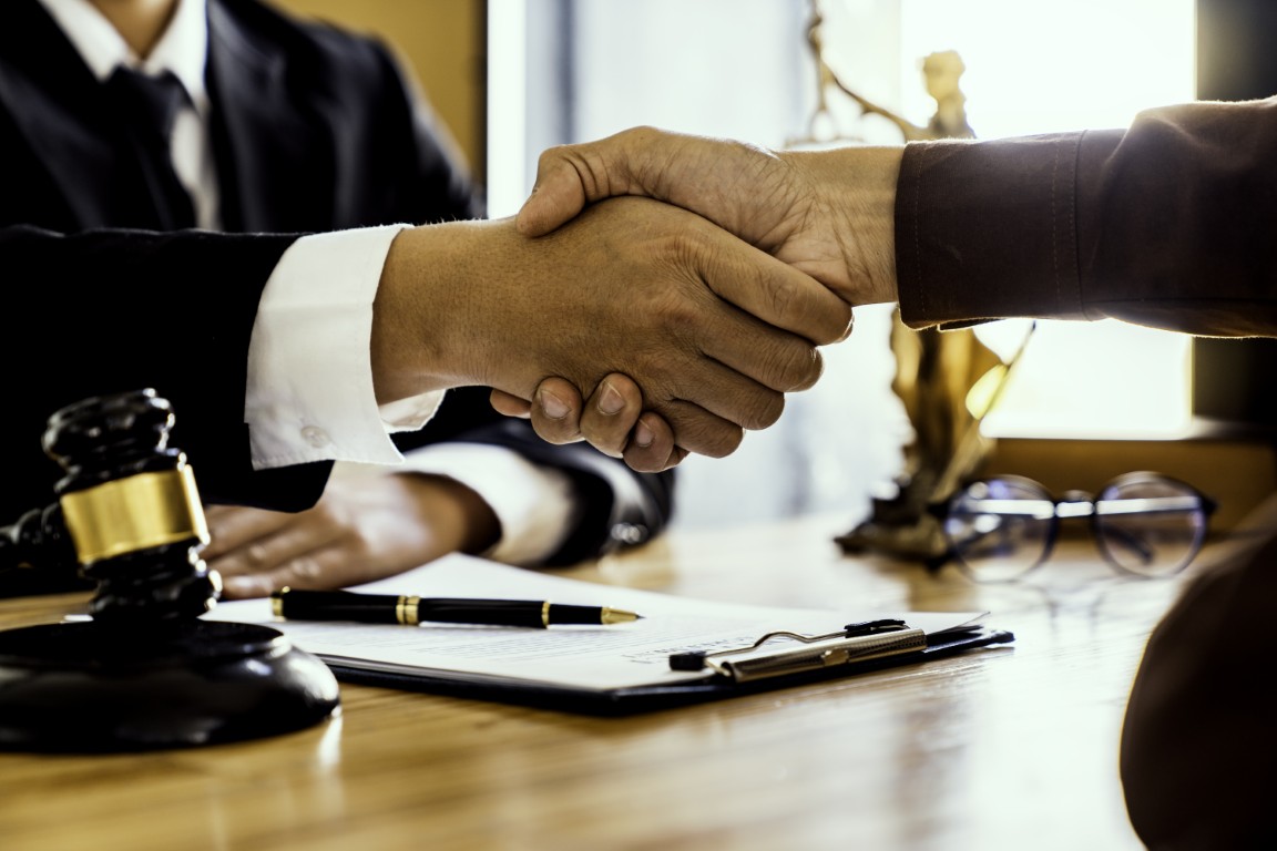 A lawyer shaking hands with a client