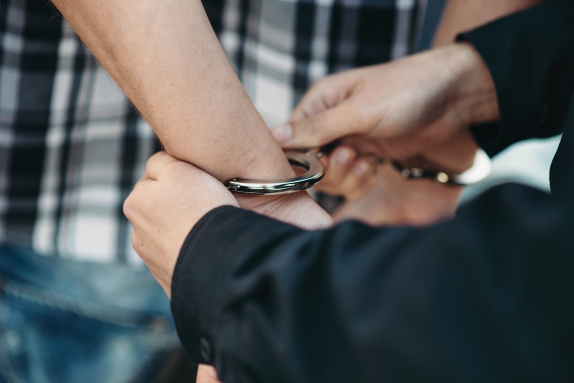A man being put in handcuffs