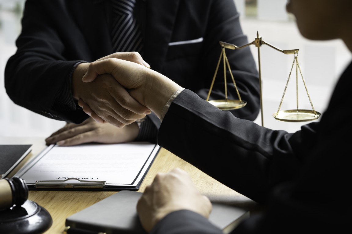 A lawyer shaking hands with a client