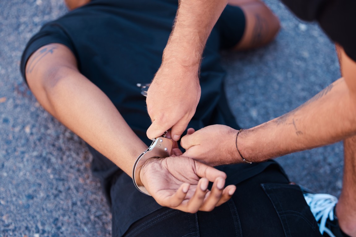 A man being placed under arrest