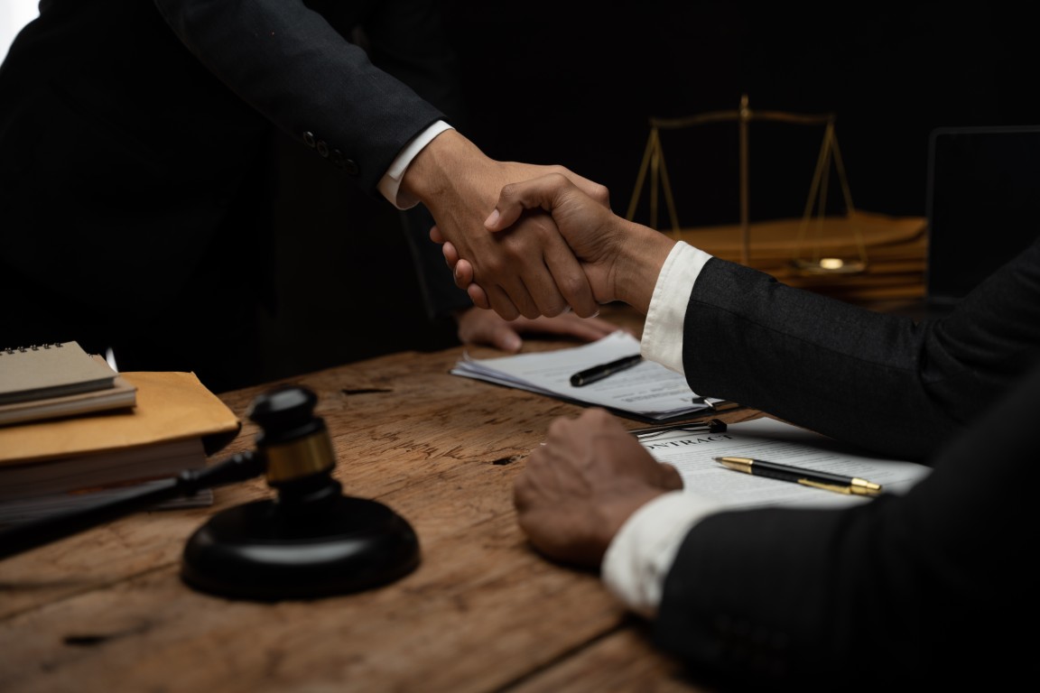 A lawyer shaking hands with a client